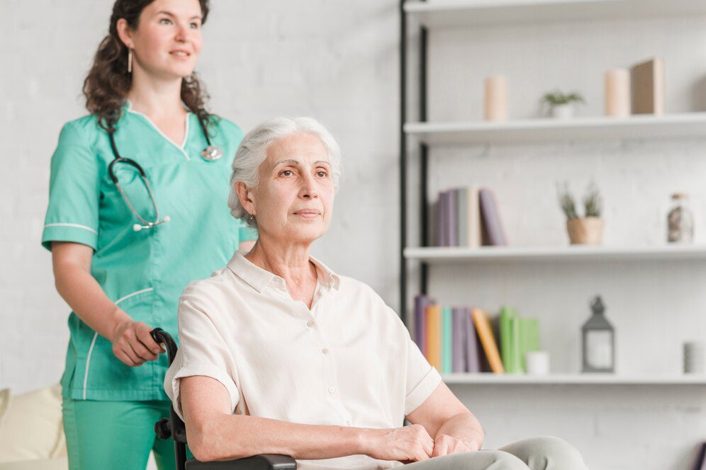 young-nurse-assisting-disabled-senior-woman-sitting-wheel-chair